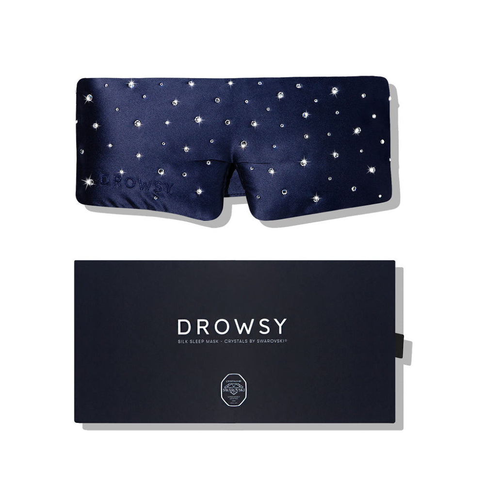 Navy blue sleep mask with crystals and packaging on a white background