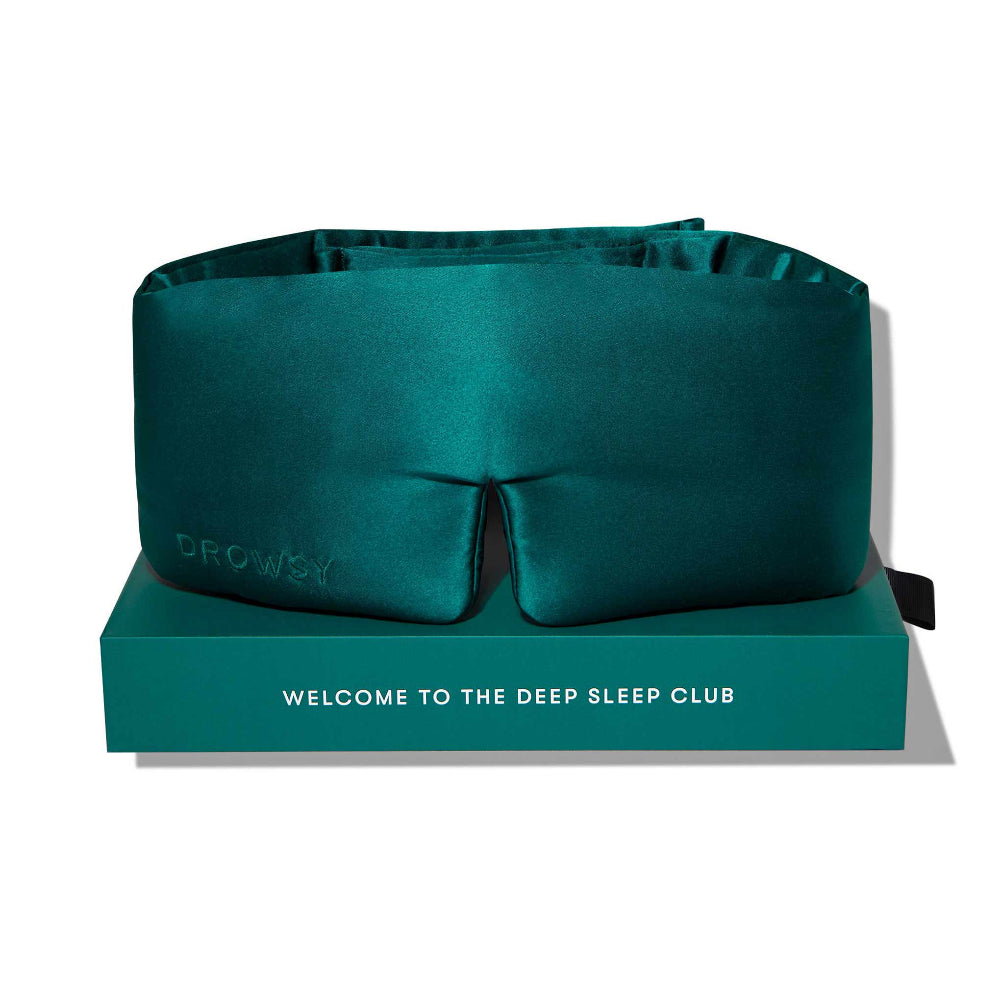 Green sleep mask on a green box with text 'Welcome to the Deep Sleep Club'.