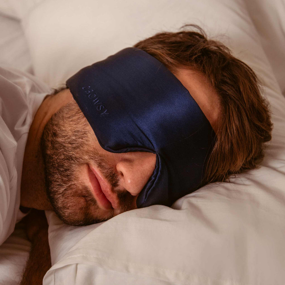 Person sleeping with a blue sleep mask on