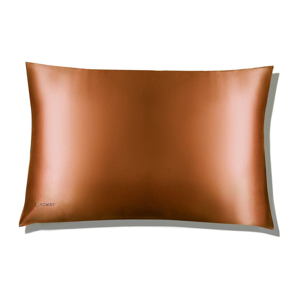 A bronze-coloured Pumpkin spice silk pillowcase with a smooth texture, displayed on a plain white background