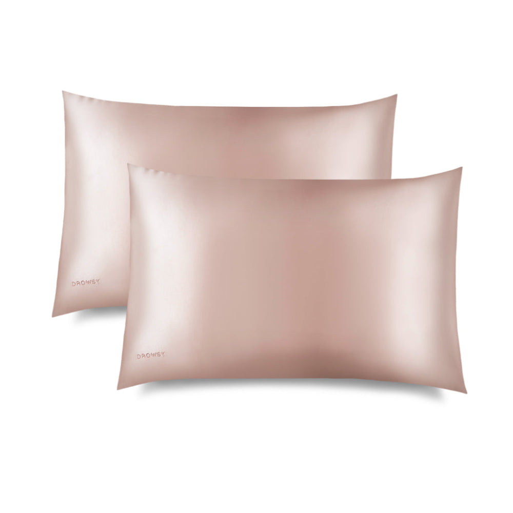 Two sunset pink drowsy pillowcases on a white background