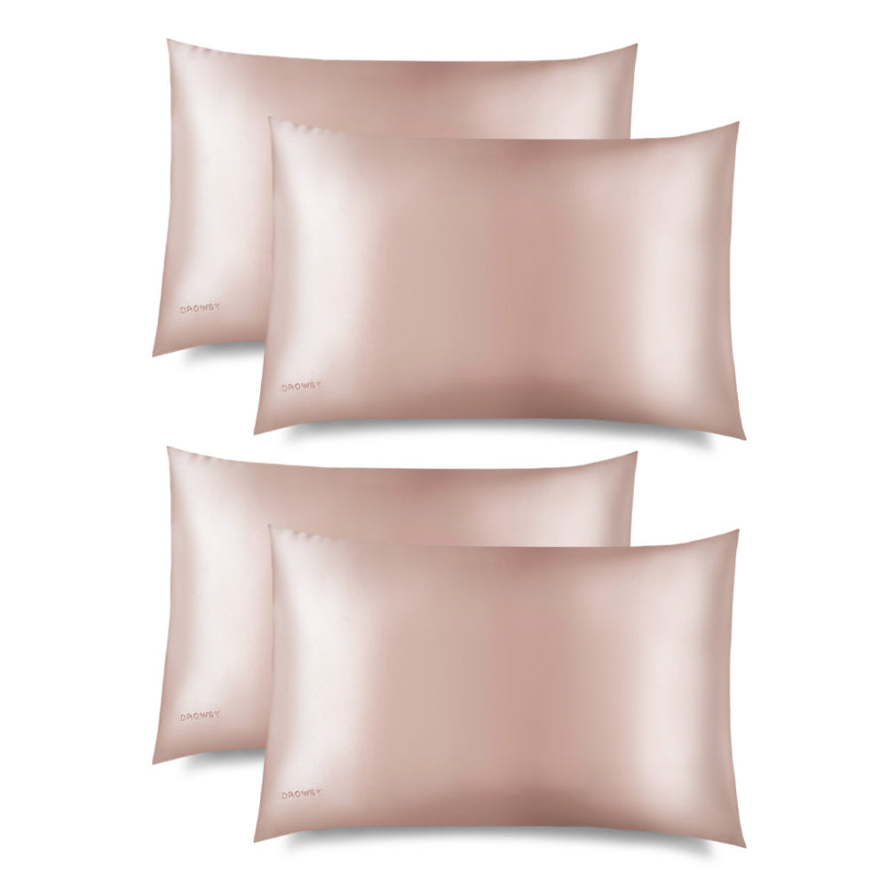 Four sunset pink drowsy silk pillowcases on a white background