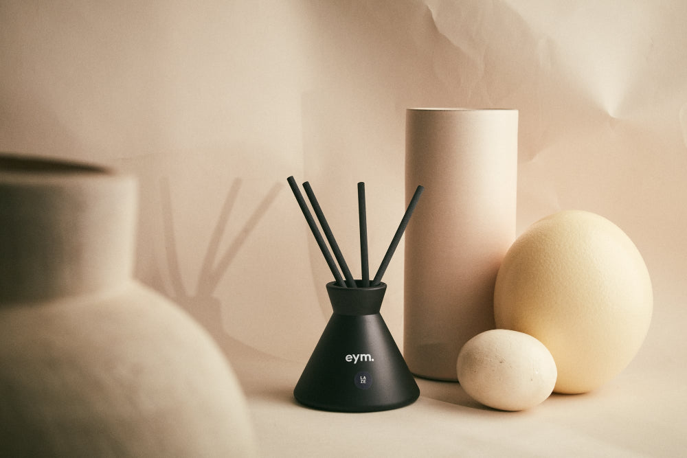 Black diffuser with 'eym' branding on a neutral background