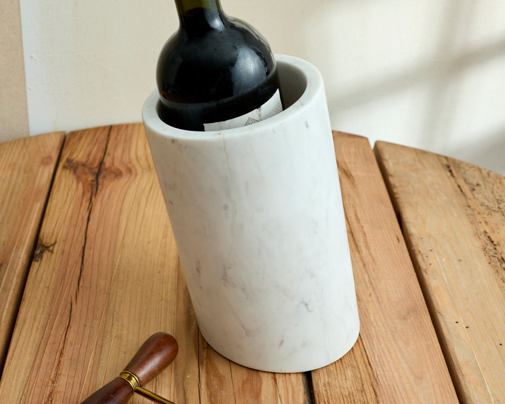 White wine cooler marble with a bottle of wine on a wooden surface