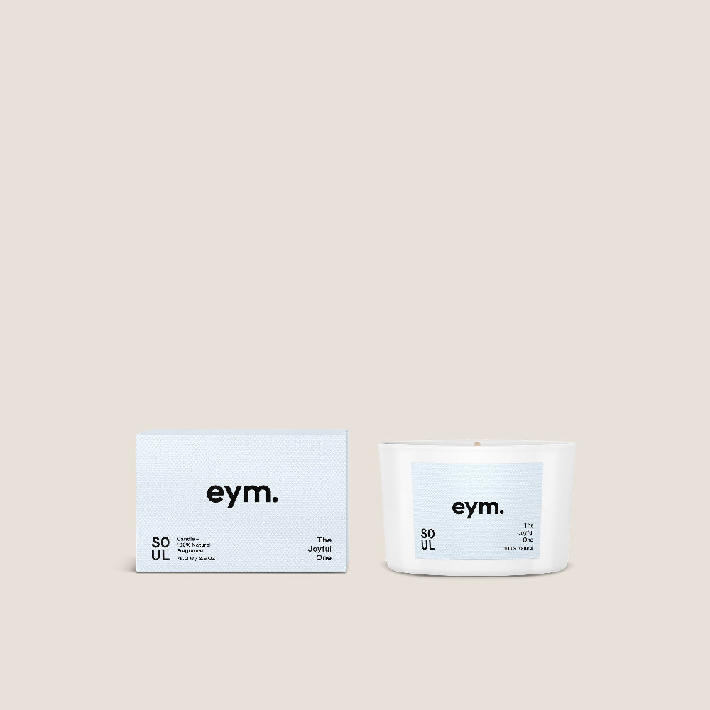 White candle with packaging with labels named eym and the candle called 'Soul' on a beige background