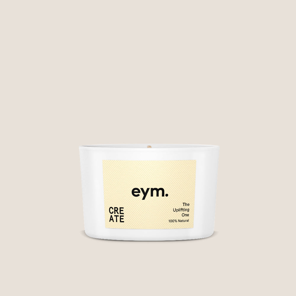 Mini Create Candle with a yellow label on a beige background