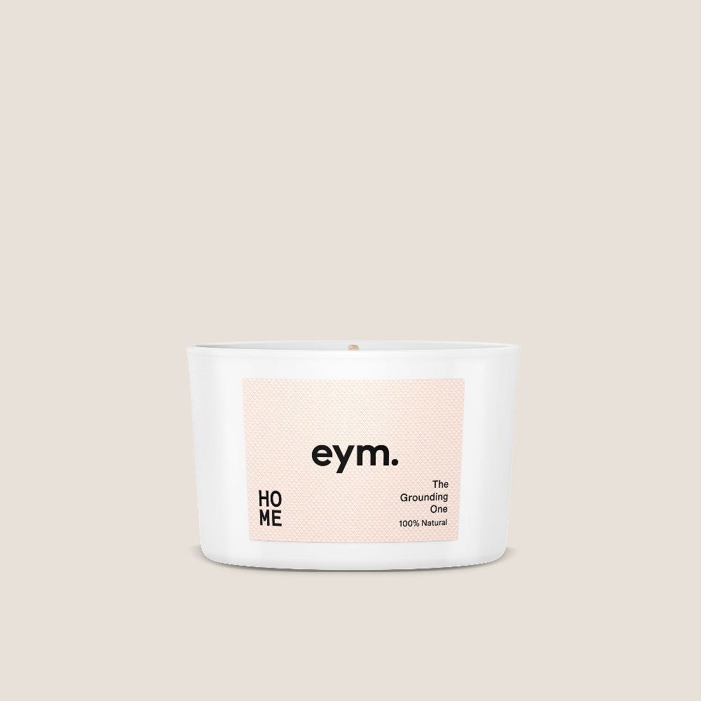 'Home' Candle with 'eym.' pink label on a beige background