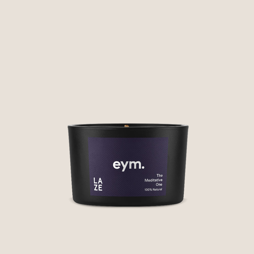 Black mini candle with purple label The meditative one featuring 'eym' on a beige background