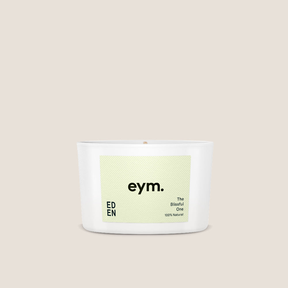 White Candle vessel called 'eden' with 'eym.' label on a beige background
