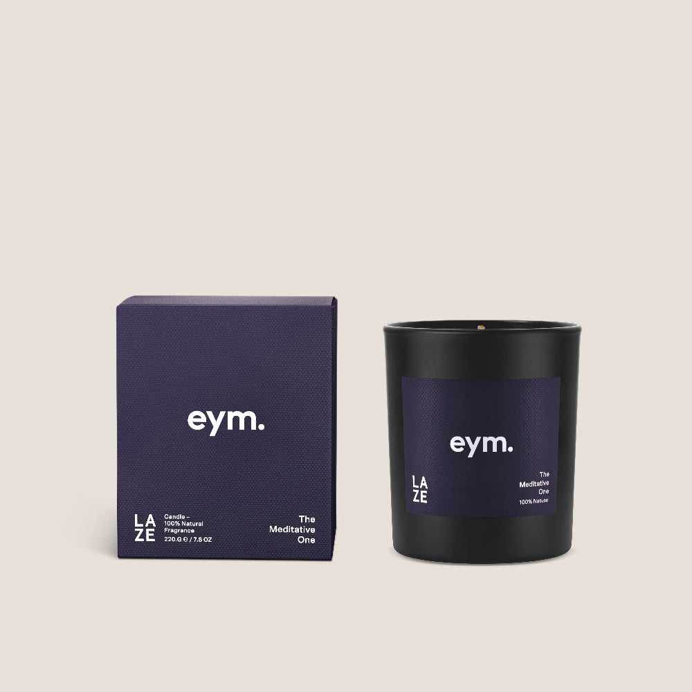 Black candle with purple packaging featuring 'eym.' brand on a beige background