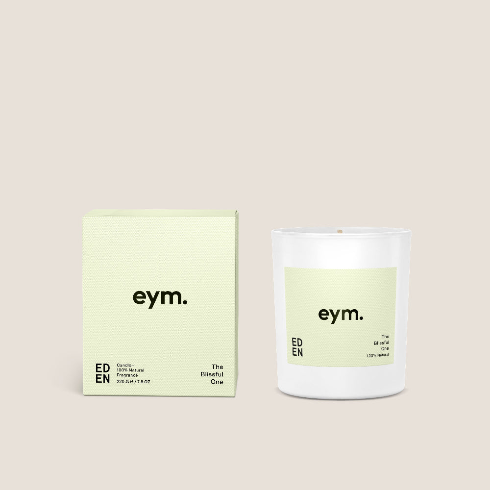Candle and packaging with 'eym.' branding on a beige background