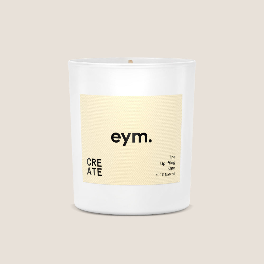 White Candle vessel with a yellow 'eym' label on a beige background