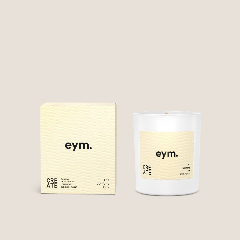 White Candle vessel and packaging with 'eym.' branding on a beige background
