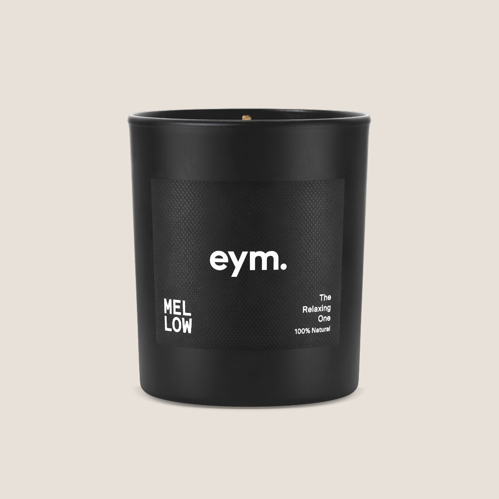 Black candle vessel with 'eym' branding on a beige background