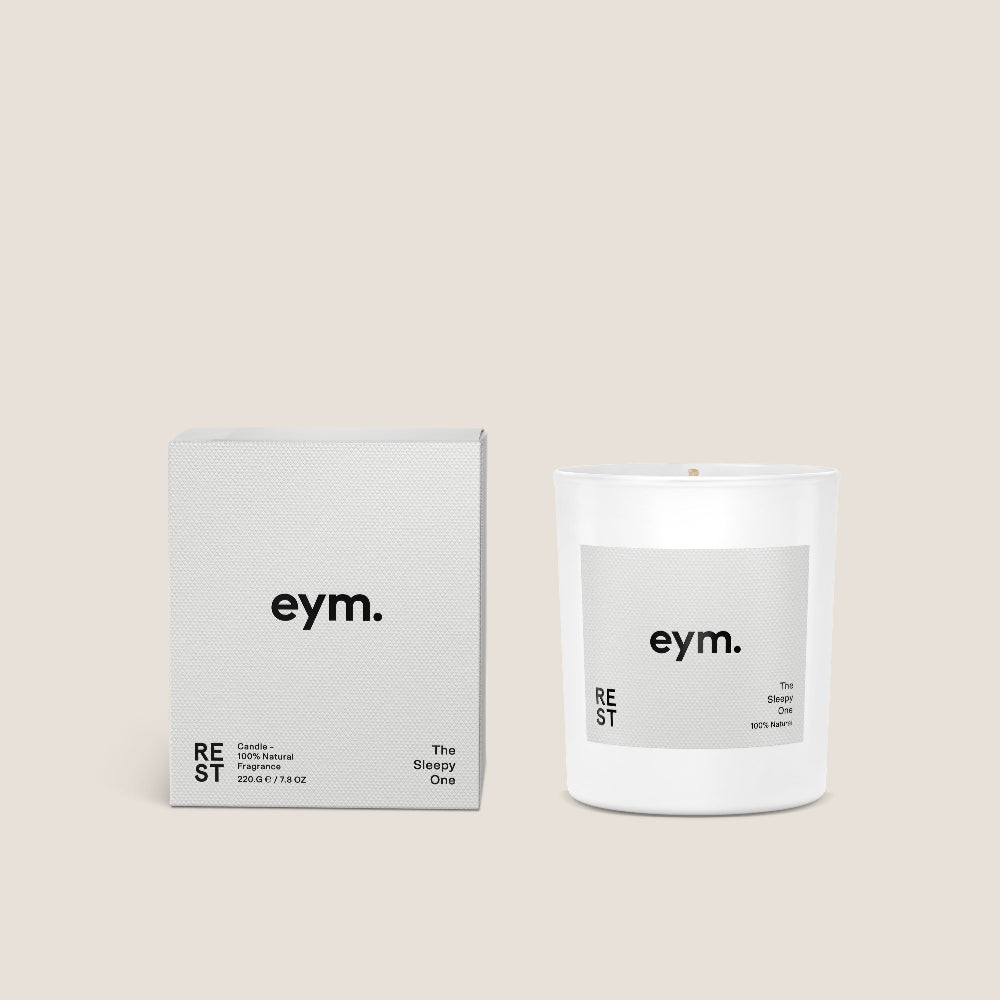 White Candle Vessel and packaging with 'eym.' branding on a beige background