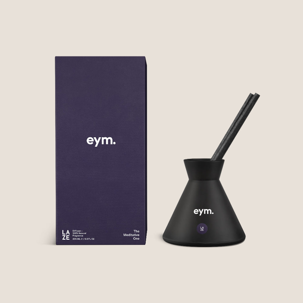 Black eym diffuser vessel with packaging on a beige background