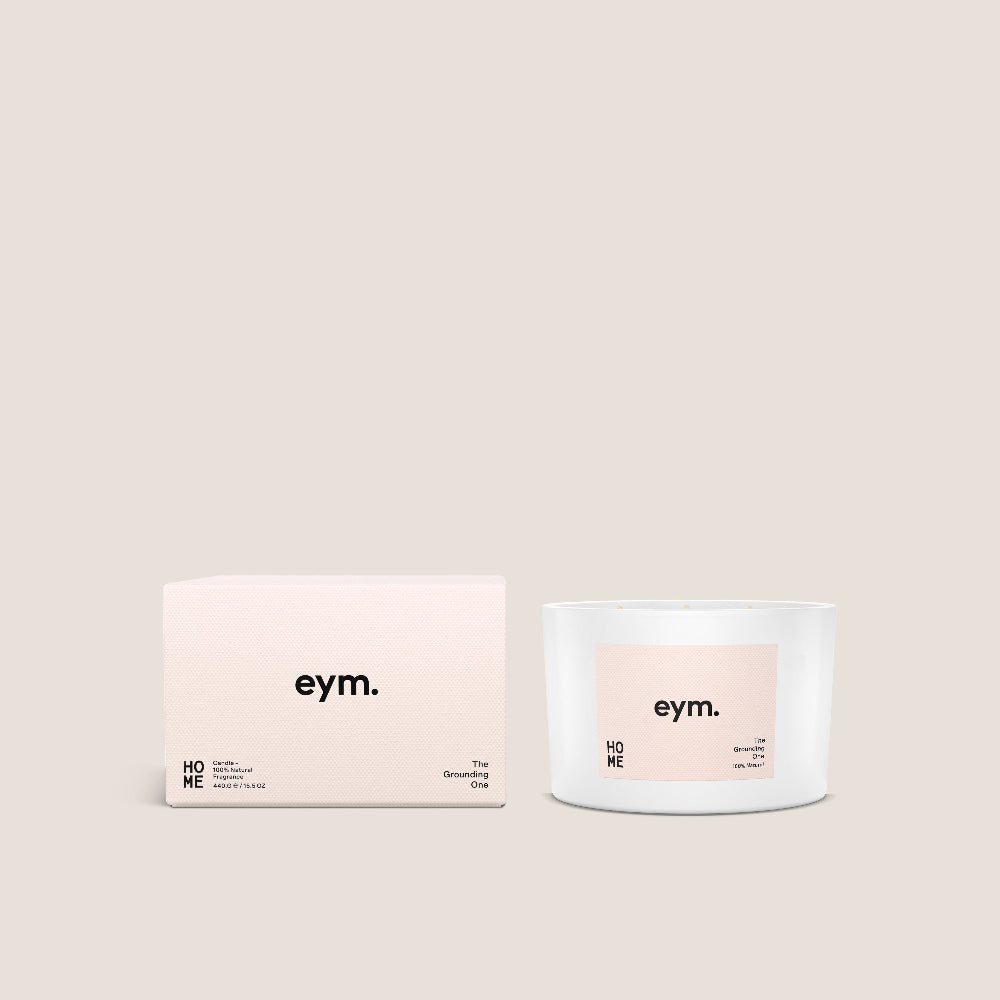 White candle 3 Wick vessel and packaging with 'eym.' branding on a light beige background