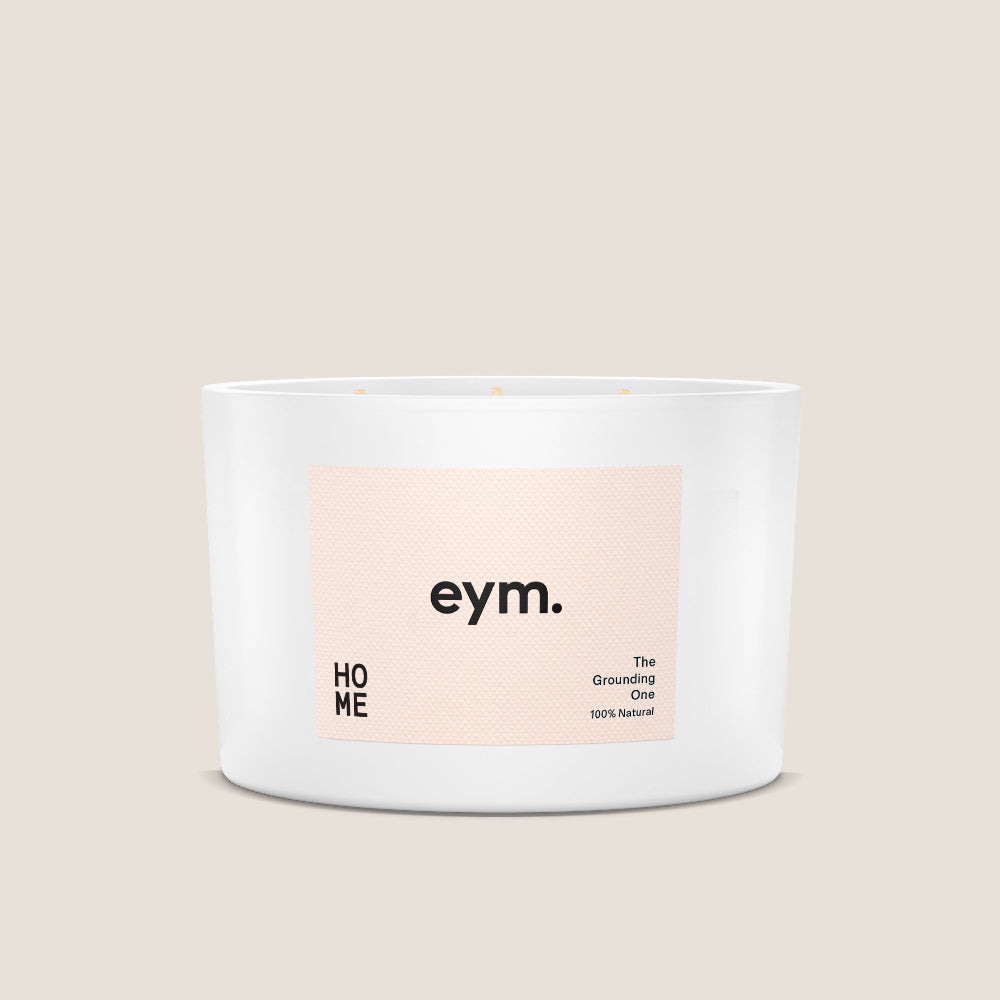 Eym Home White candle with a label on a beige background