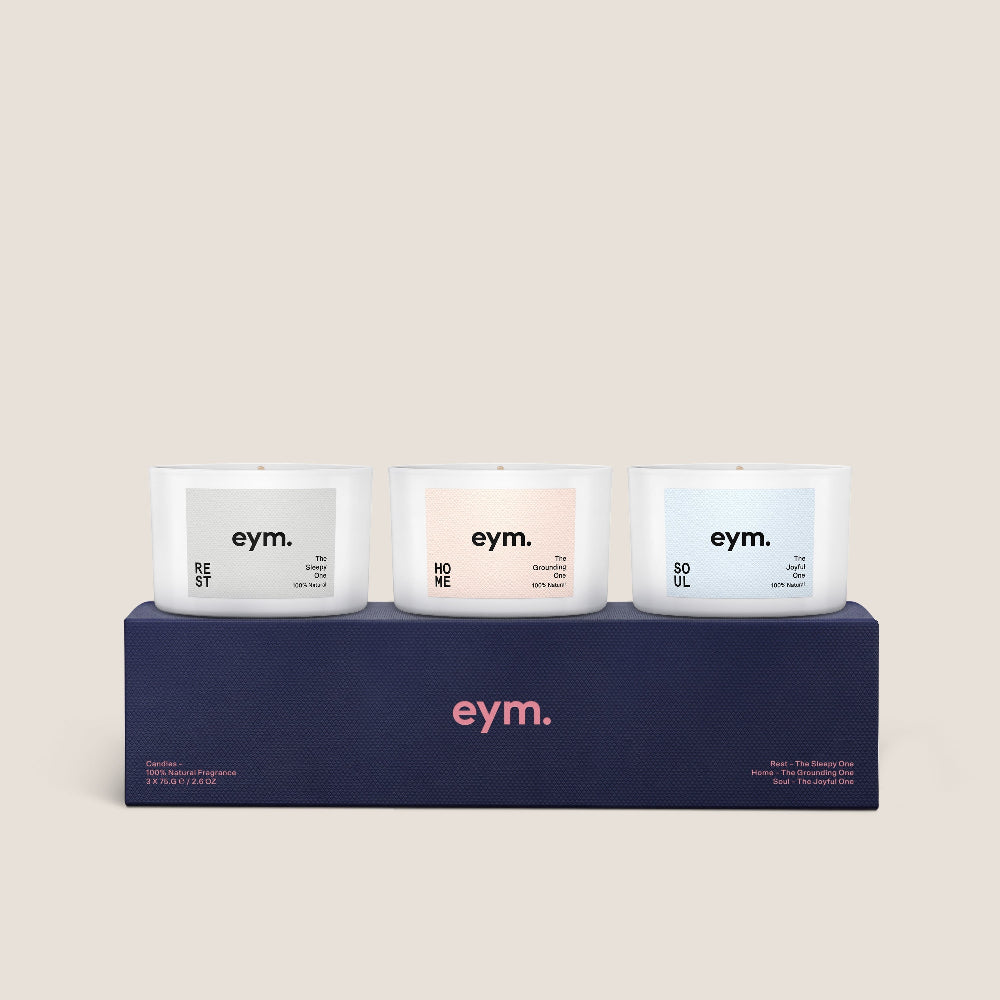 Three candles gift set with 'eym.' branding on a matching box against a beige background