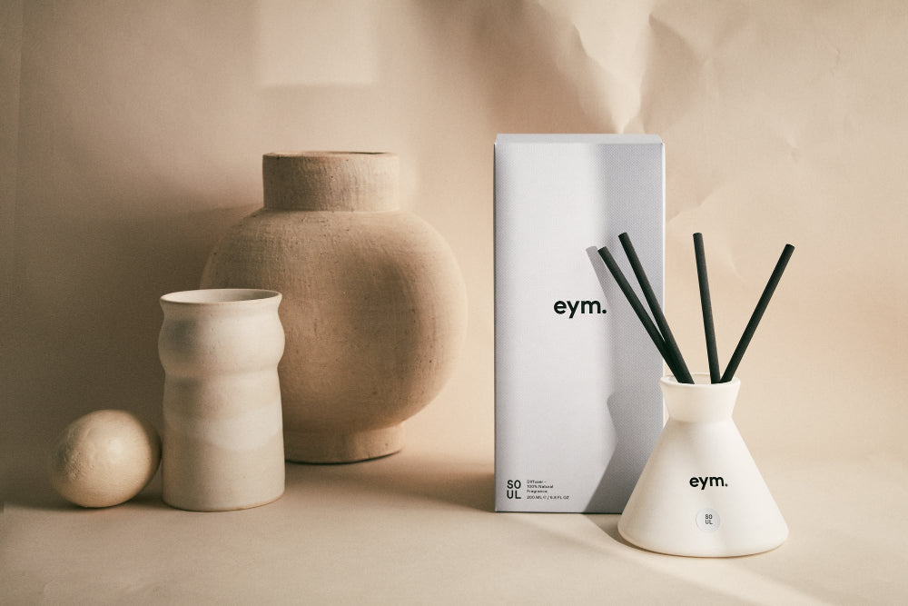 Decorative diffuser with 'eym.' branding on a neutral background