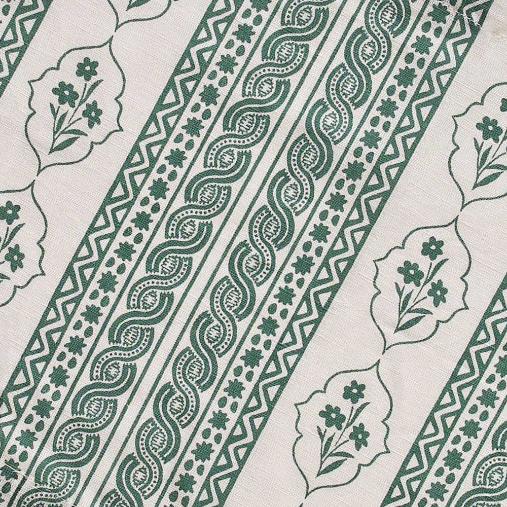 Green and white patterned fabric with floral and geometric designs.