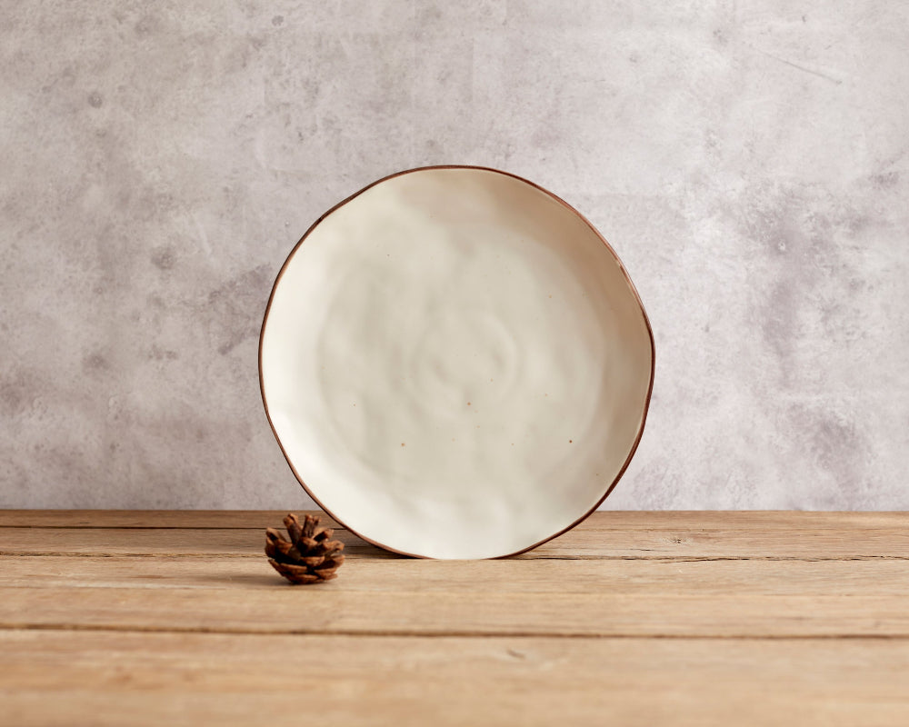 Ceramic plate on a wooden surface with a textured wall background