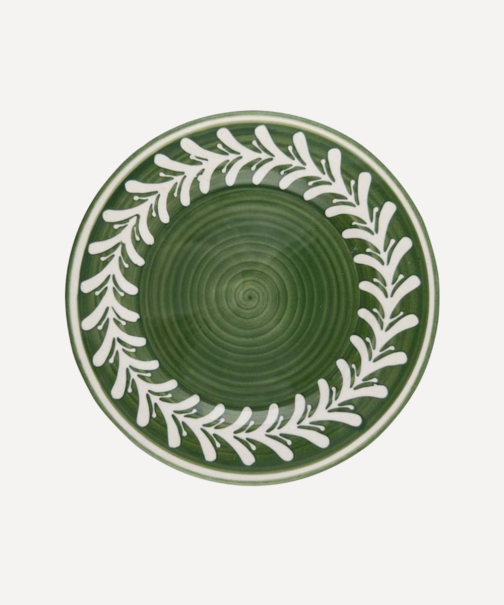 Green ceramic plate with white Fern leaf pattern on a white background