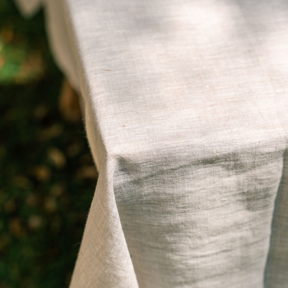 Close-up of a textured natural fabric with a blurred green background