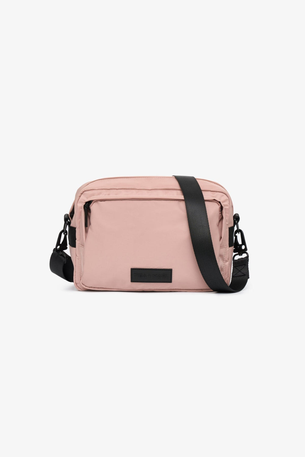 Pink crossbody bag with black accents on a white background