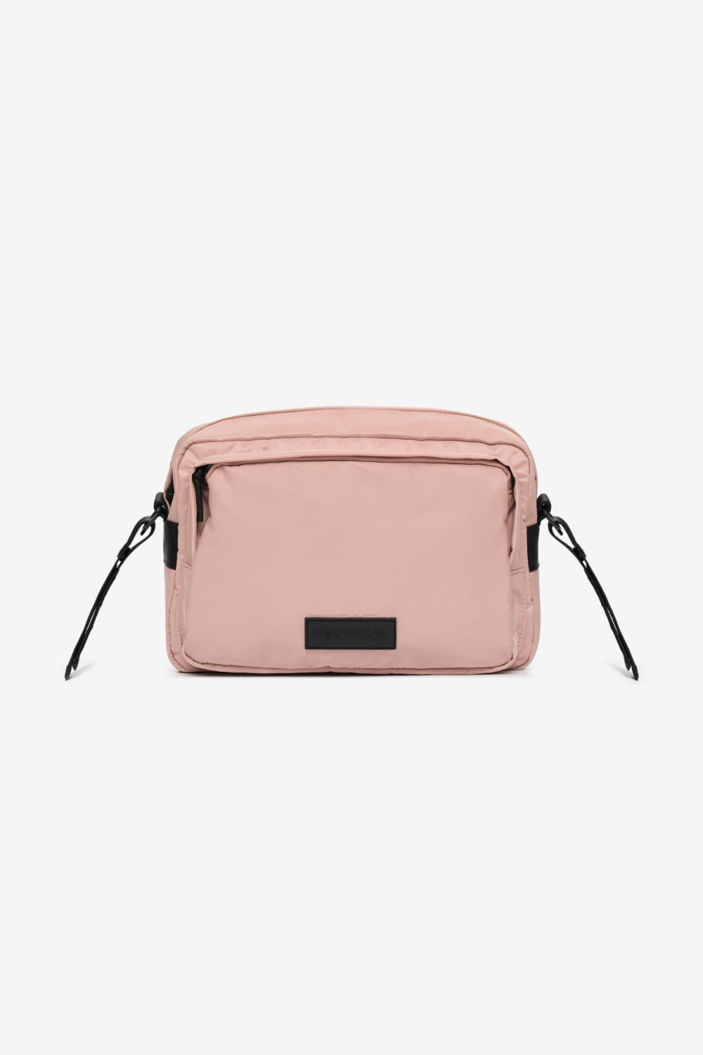 Pink crossbody bag with black straps on a white background