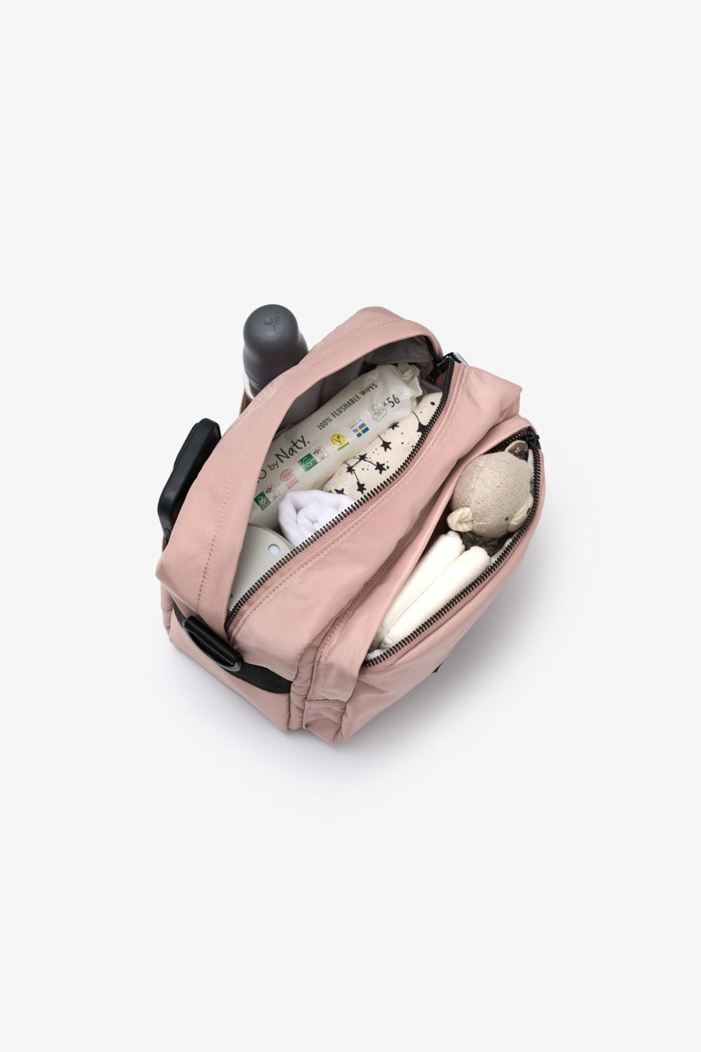 Pink backpack with baby items on a white background