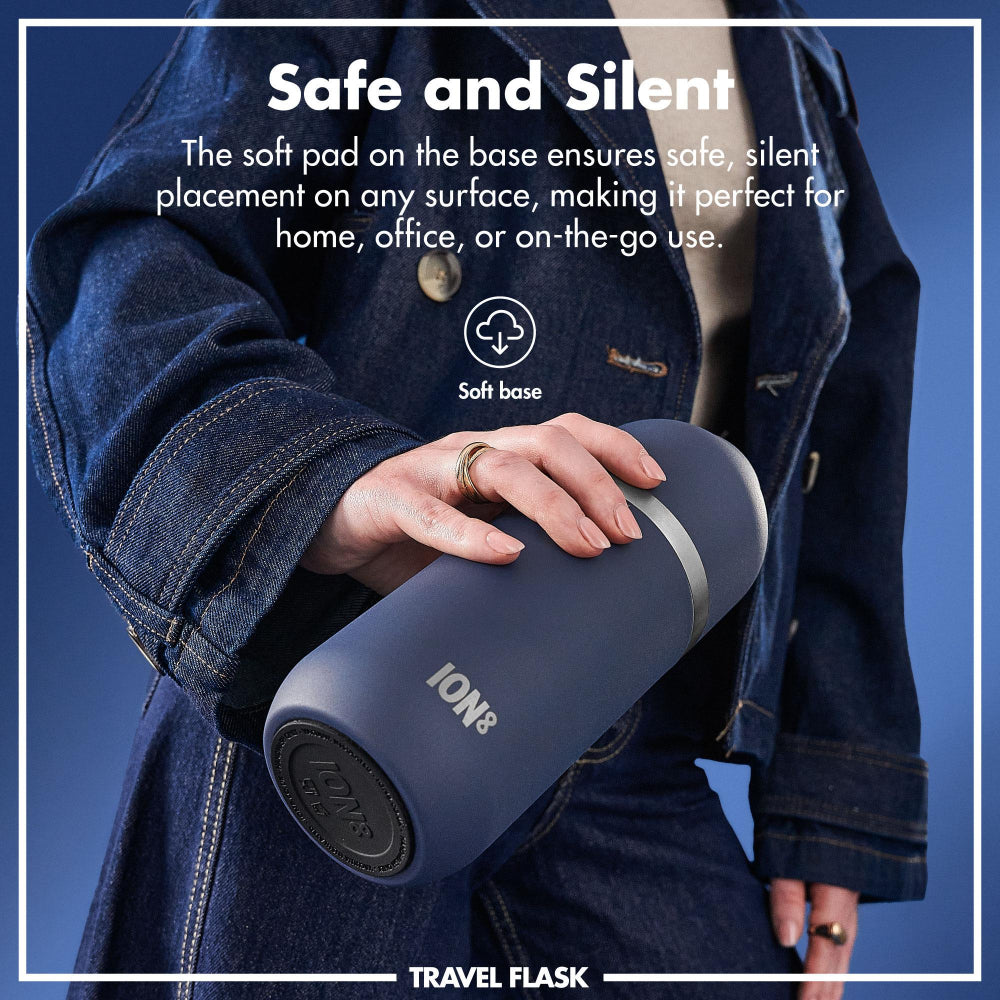 Person holding a blue travel flask with text about its safe and silent features.