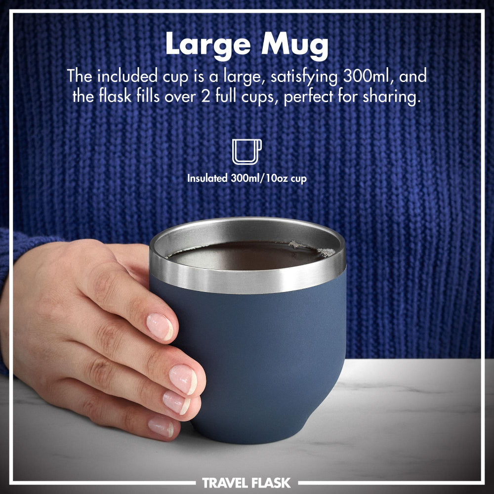 Hand holding a blue insulated mug with text about its capacity and use.