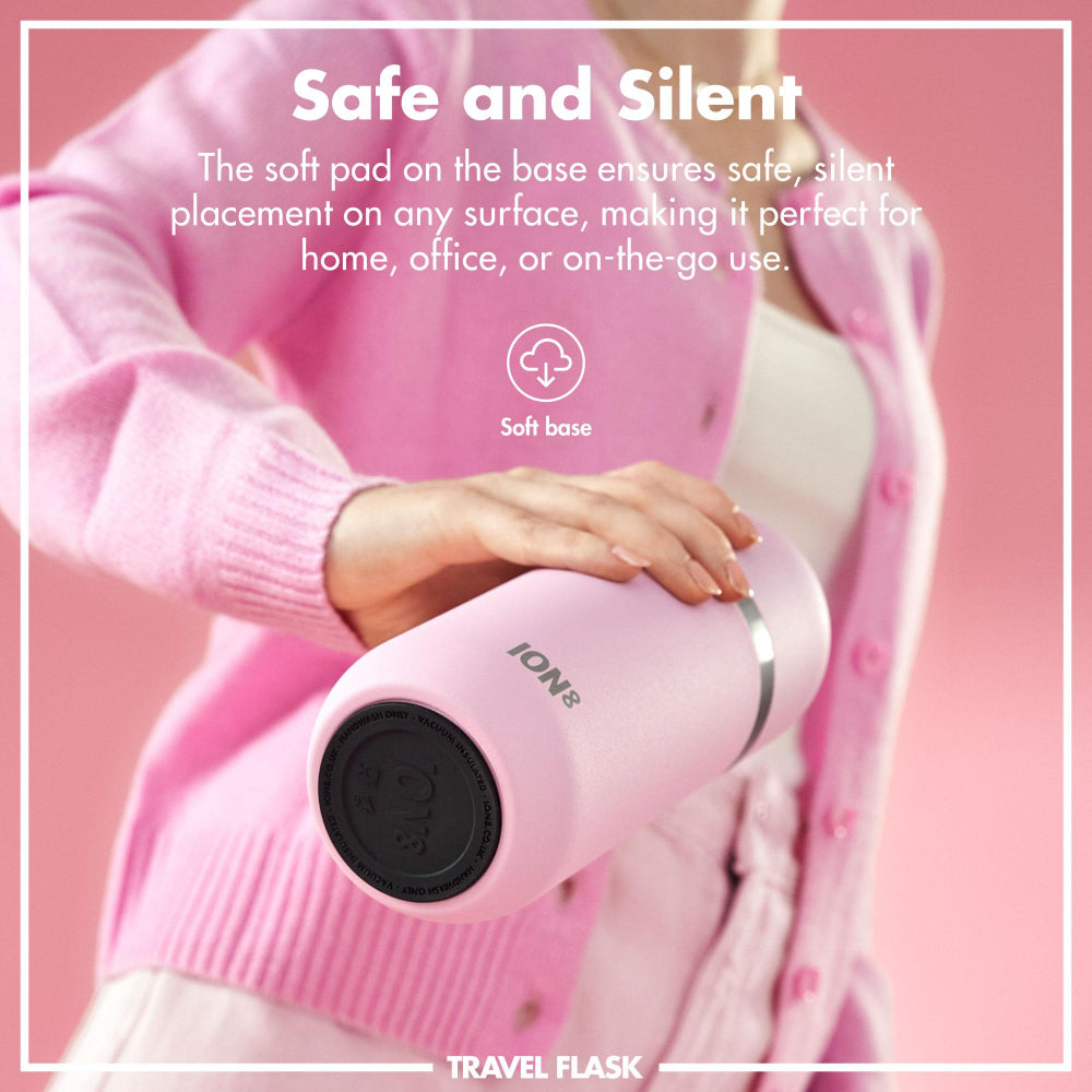 Person holding a pink travel flask with text about its safe and silent design on a pink background.