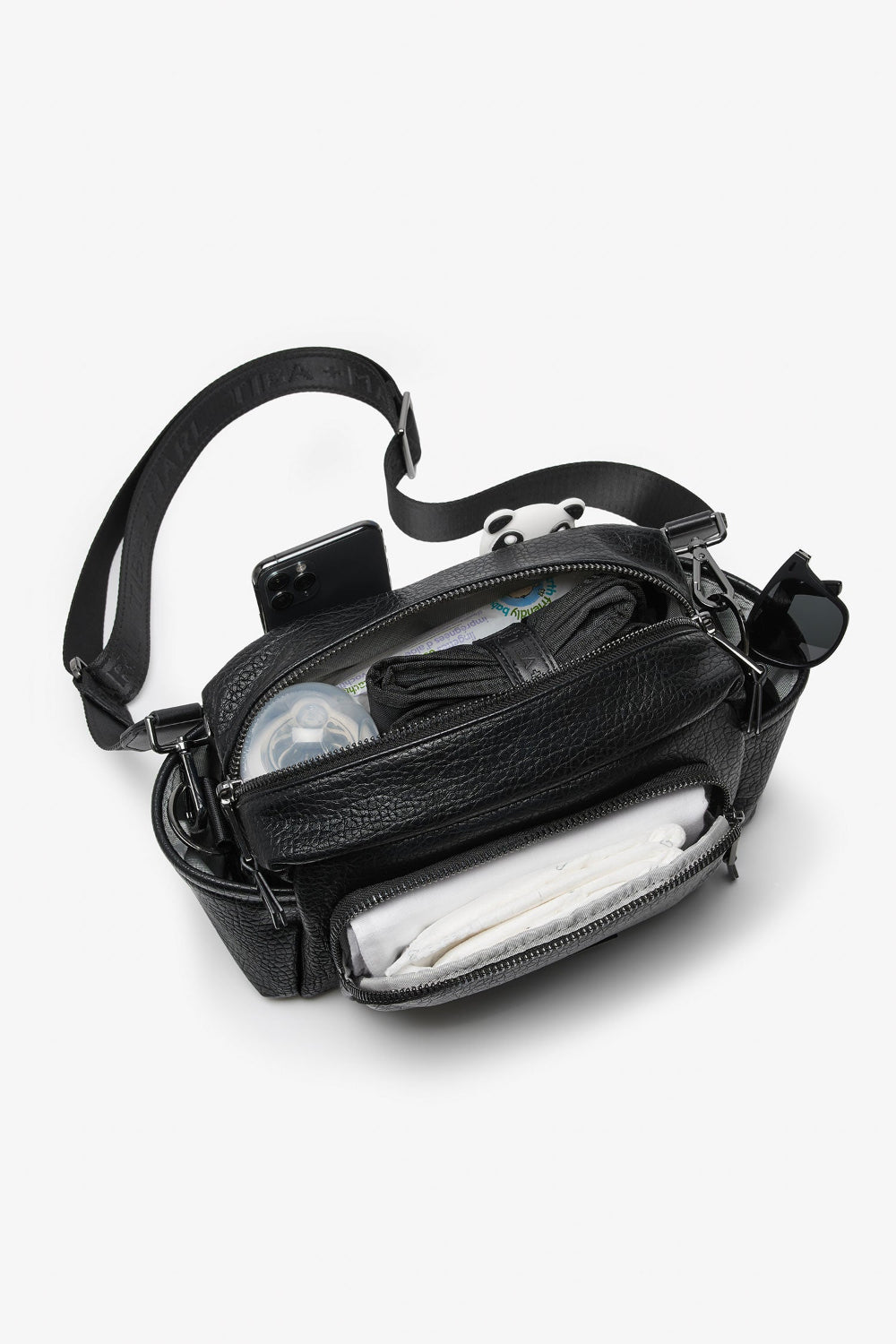 Black leather bag with compartments on a white background