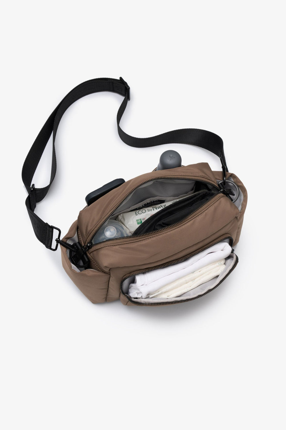 Mocha crossbody bag with black strap on a white background showcasing products within and zip open