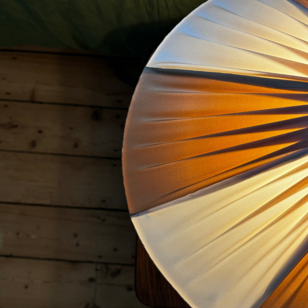 Close-up of Lampshade Ivory and Gold Coloured with a wooden background