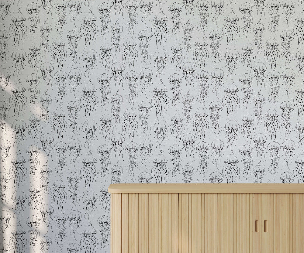 Wallpaper with jellyfish pattern on a light grey background, with a wooden cabinet in the foreground.