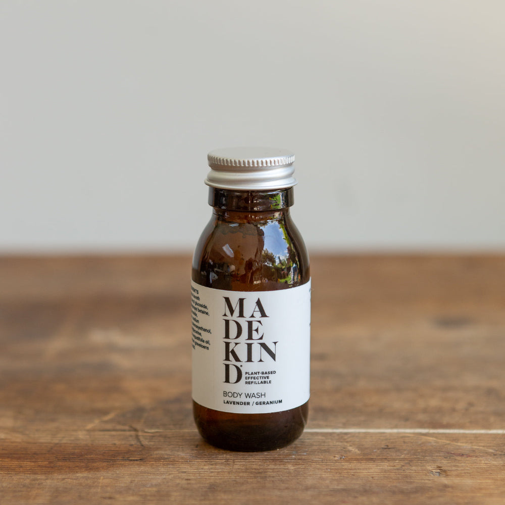 Brown bottle Lavender Geranium Body wash with Madekind label on a wooden surface