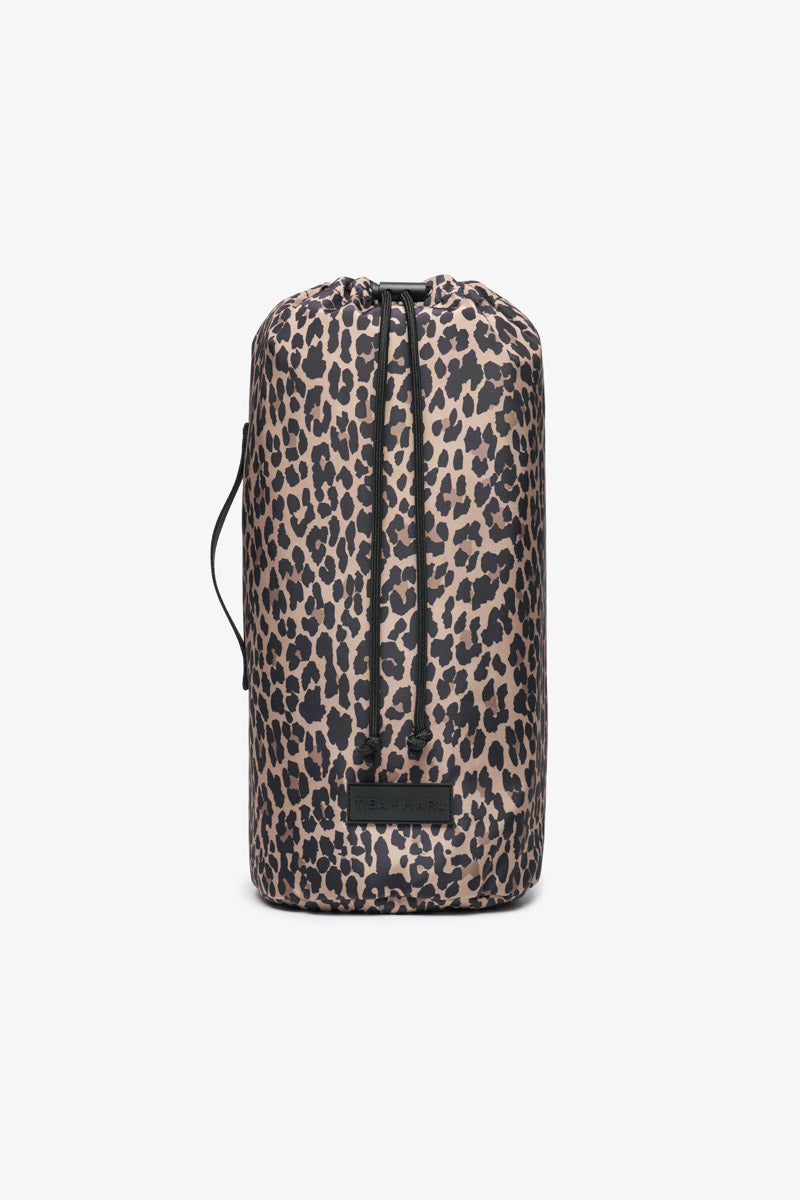Leopard print drawstring bag containing play blanket on a white background