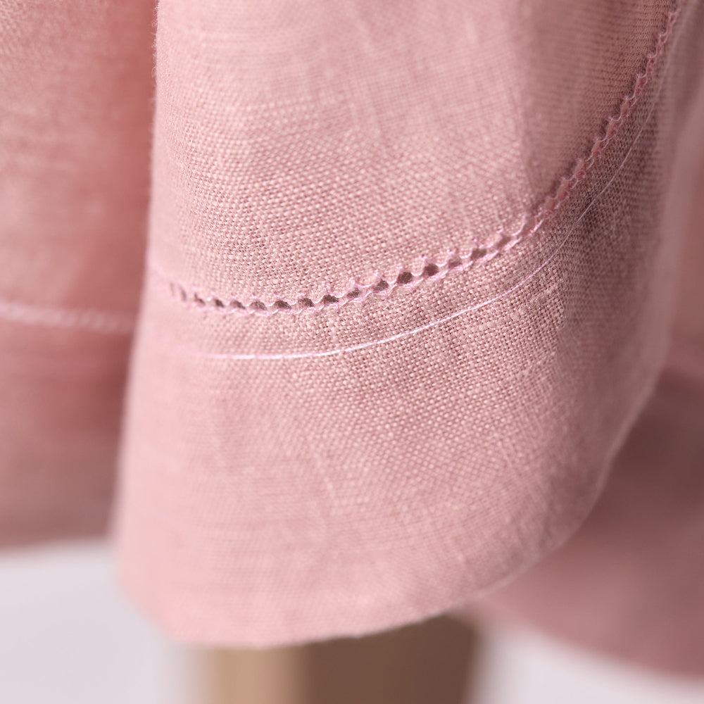 Close-up of pink fabric with a focus on stitching detail