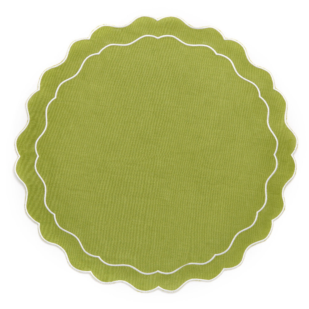Green round placemat with scalloped edge on a white background
