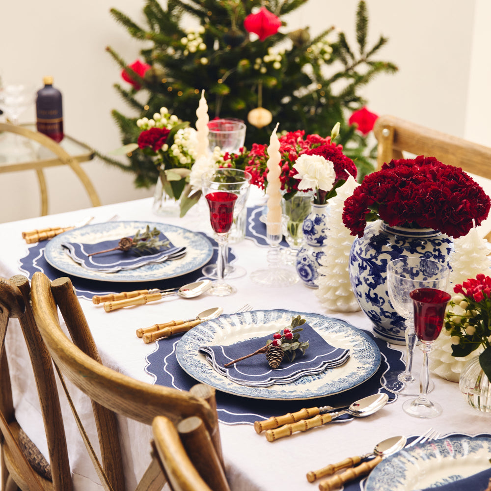 Decorative Christmas table setting with floral arrangements and candles.