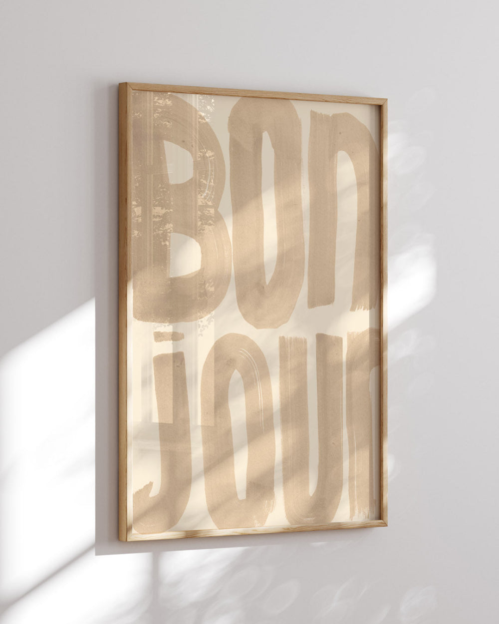 Framed artwork with 'BONJOUR' text on a light background