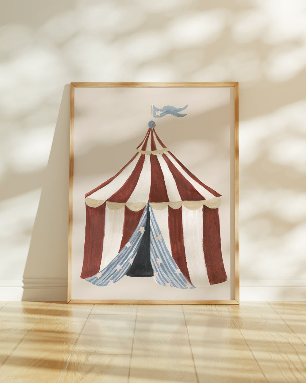 Framed artwork of a circus tent with a striped design on a beige wall.