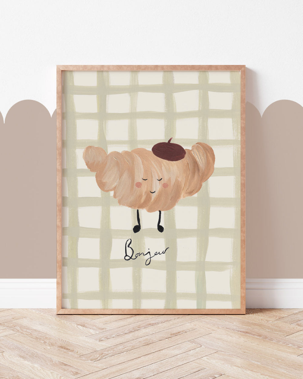 Framed artwork of a crossiant character with a checkered background on a wall.