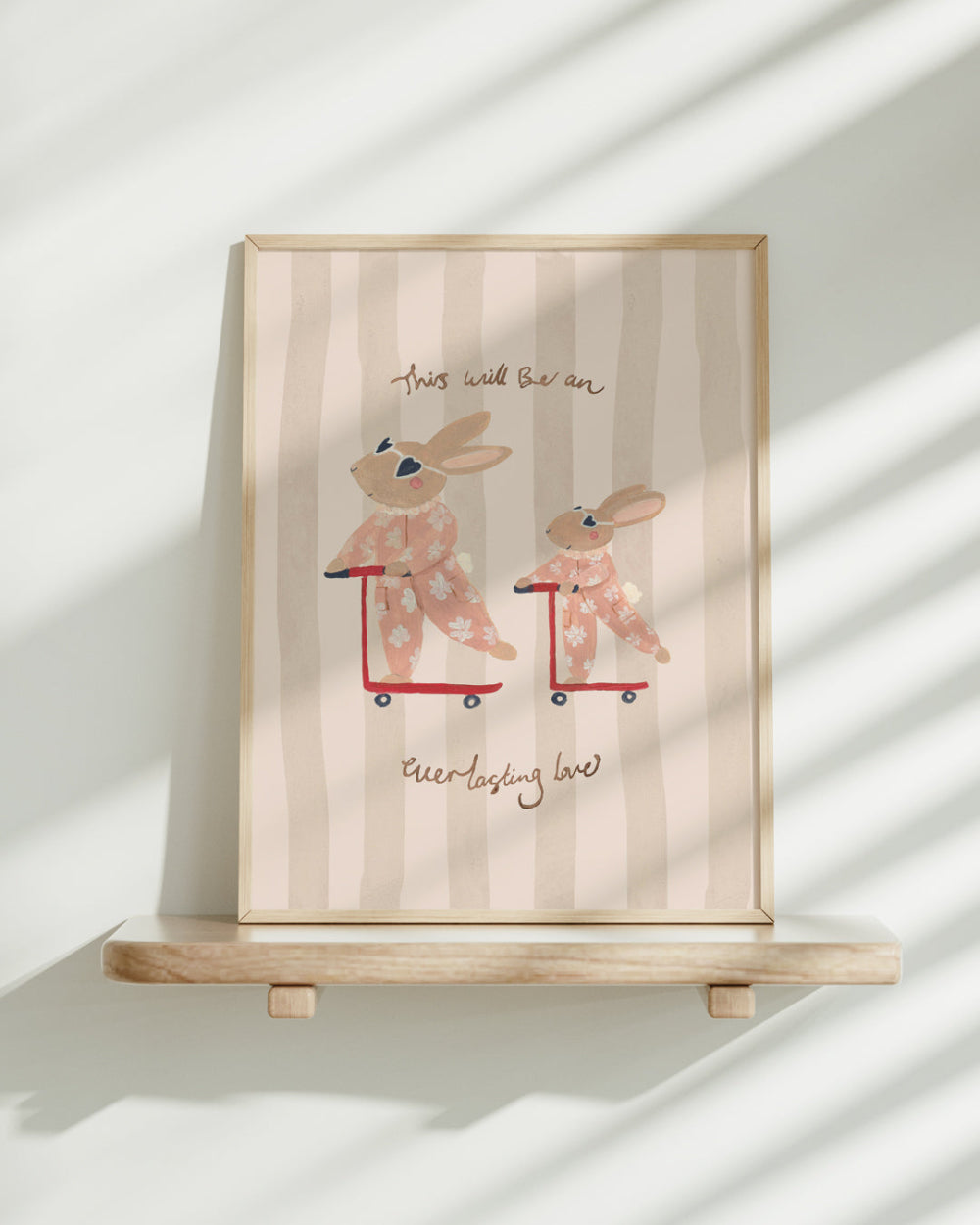 Framed artwork with cartoon bunnies on scooters and text on a striped background