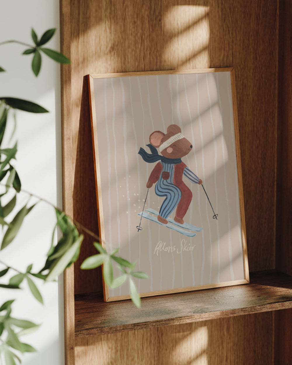Framed illustration of a mouse skiing on a wooden shelf with plants in the background