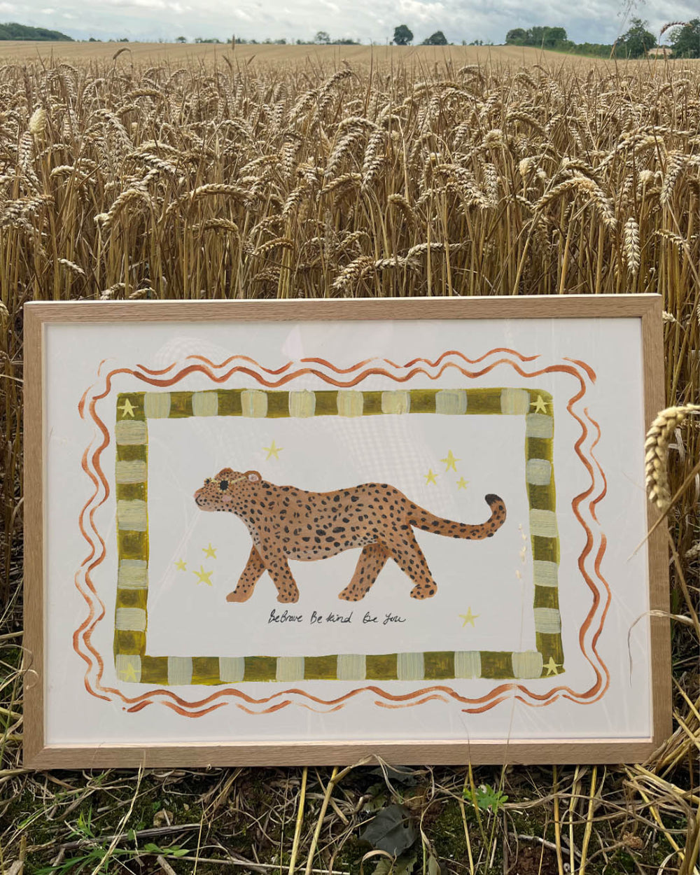 Framed artwork of a cheetah in a field of wheat