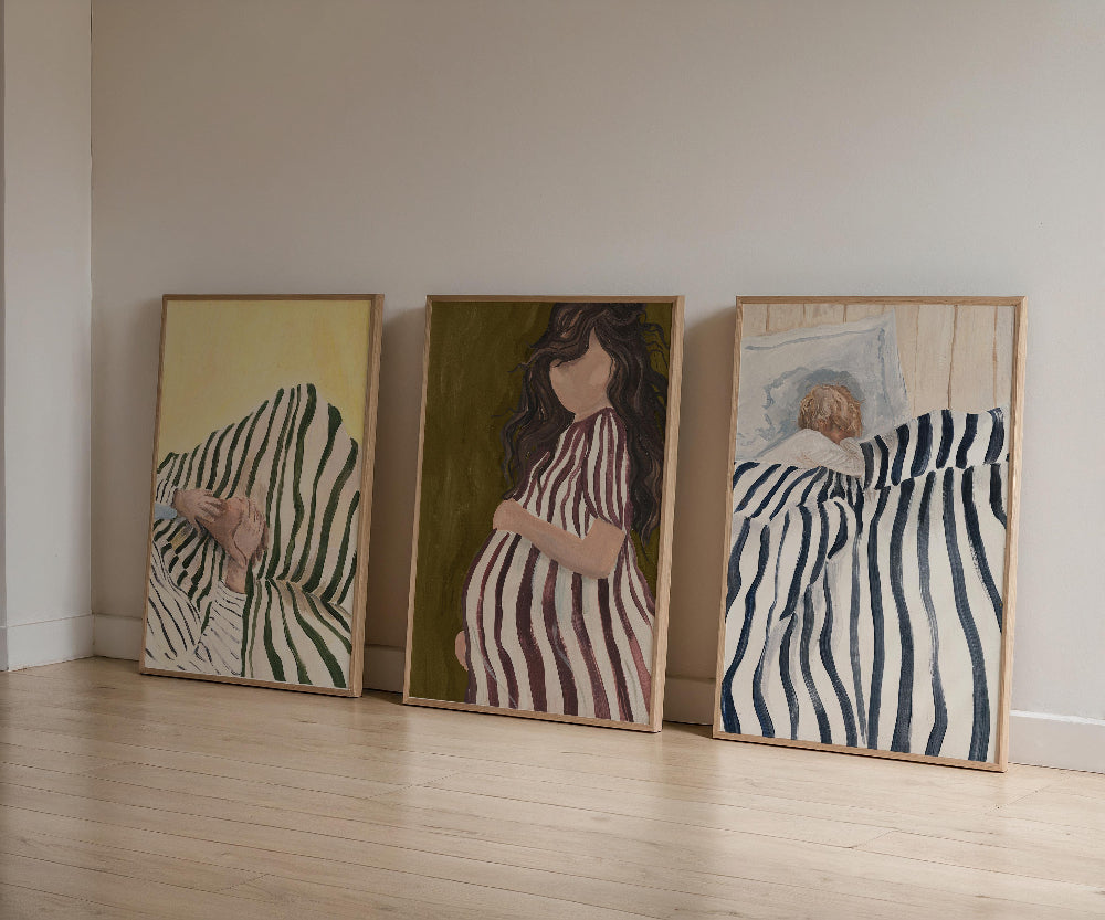 Three framed artworks on a wall with zebra patterns and a person in a striped dress.